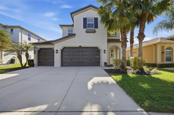 a front view of a house with a yard and garage