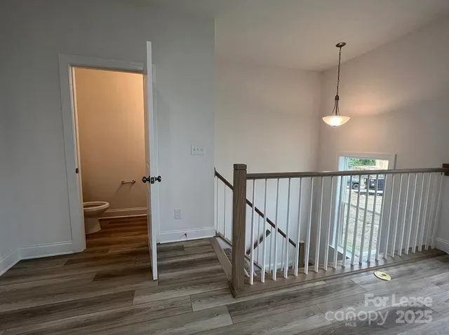 a view of hallway with wooden floor