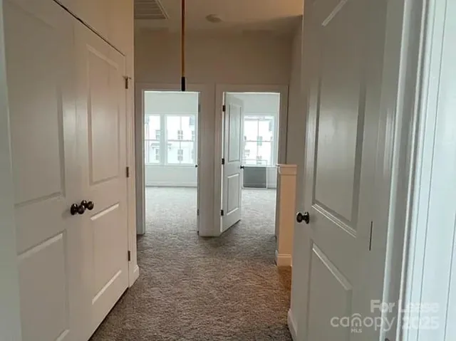 a view of a bathroom from a hallway