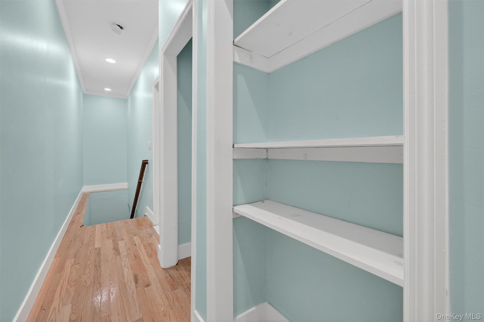 636 Throgs Neck Expressway Bronx, NY 10465 - Photo 19 of 31 Hallway featuring an upstairs landing, wood finished floors, crown molding, and recessed lighting