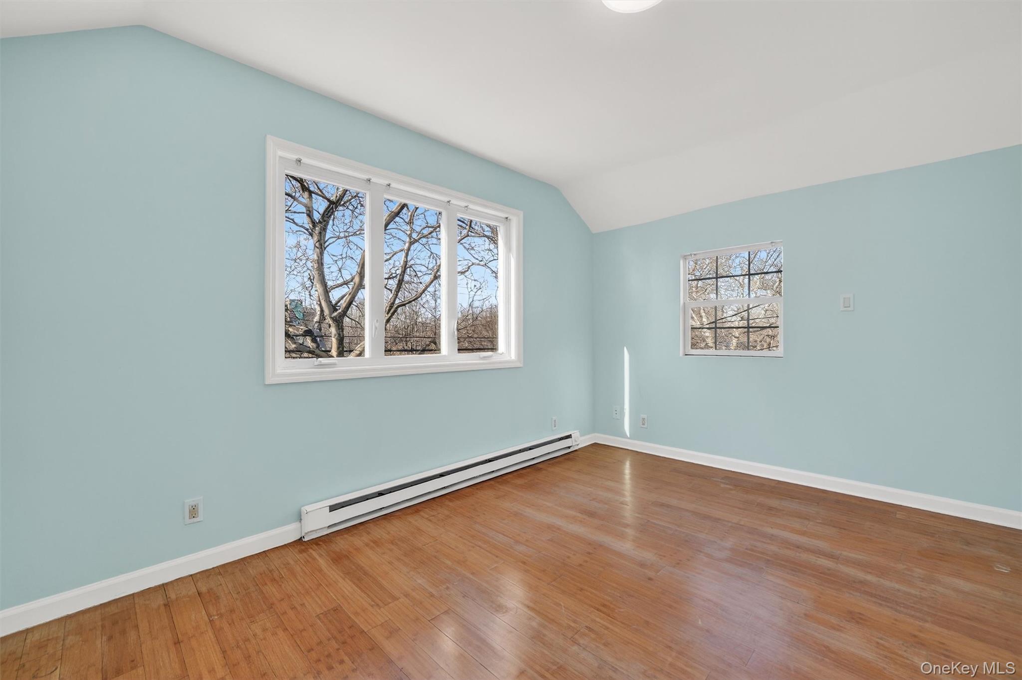 636 Throgs Neck Expressway Bronx, NY 10465 - Photo 22 of 31 Spare room with lofted ceiling, baseboard heating, and hardwood / wood-style flooring
