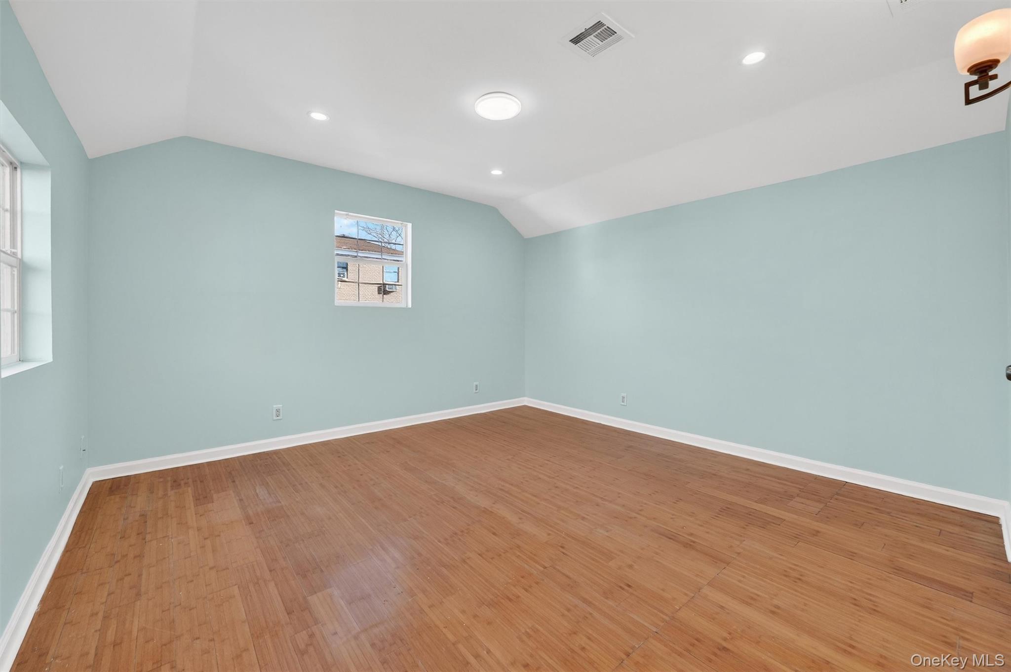 636 Throgs Neck Expressway Bronx, NY 10465 - Photo 24 of 31 Empty room featuring vaulted ceiling, wood finished floors, and recessed lighting
