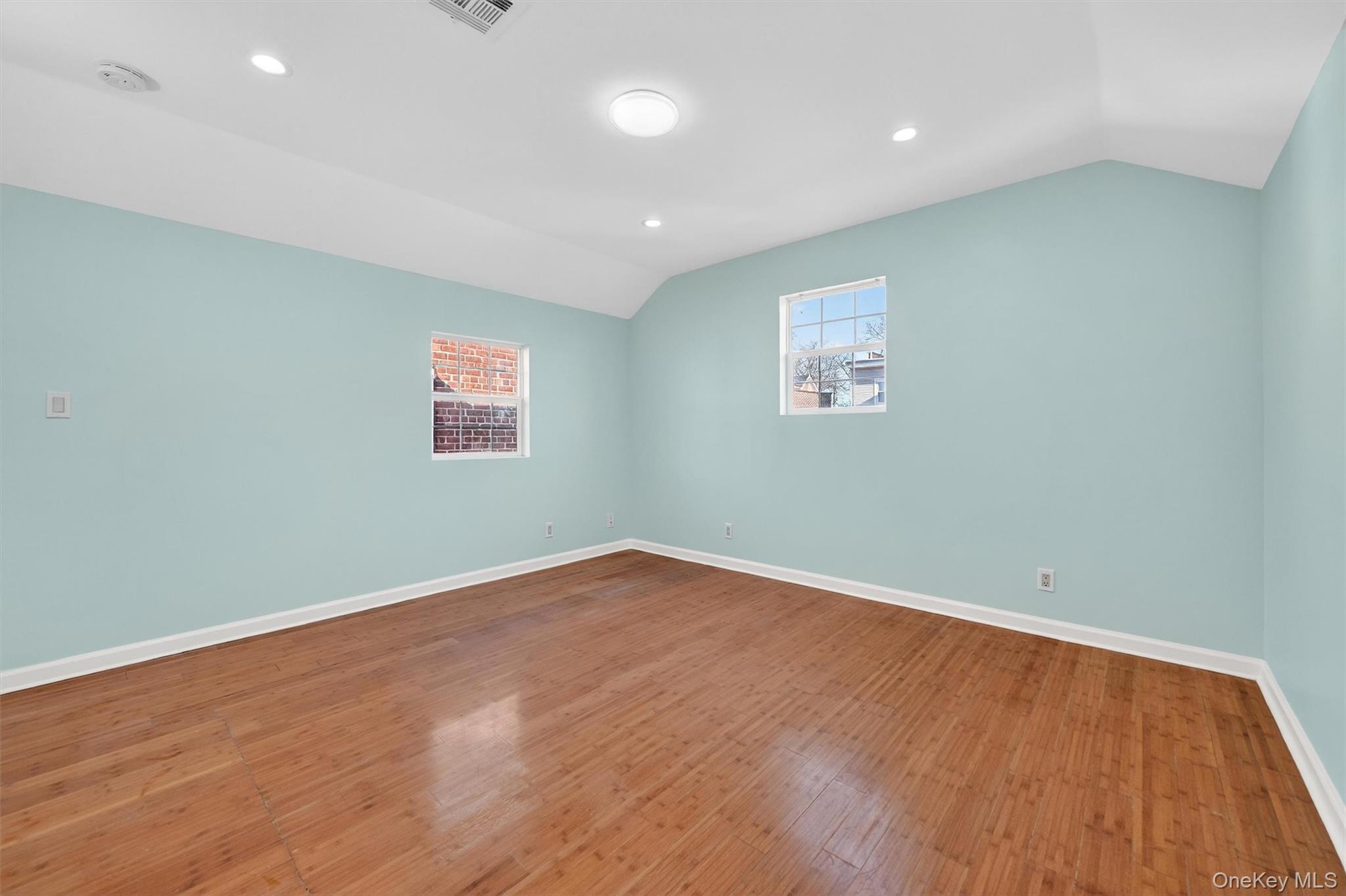 636 Throgs Neck Expressway Bronx, NY 10465 - Photo 25 of 31 Spare room featuring lofted ceiling, recessed lighting, and wood-type flooring
