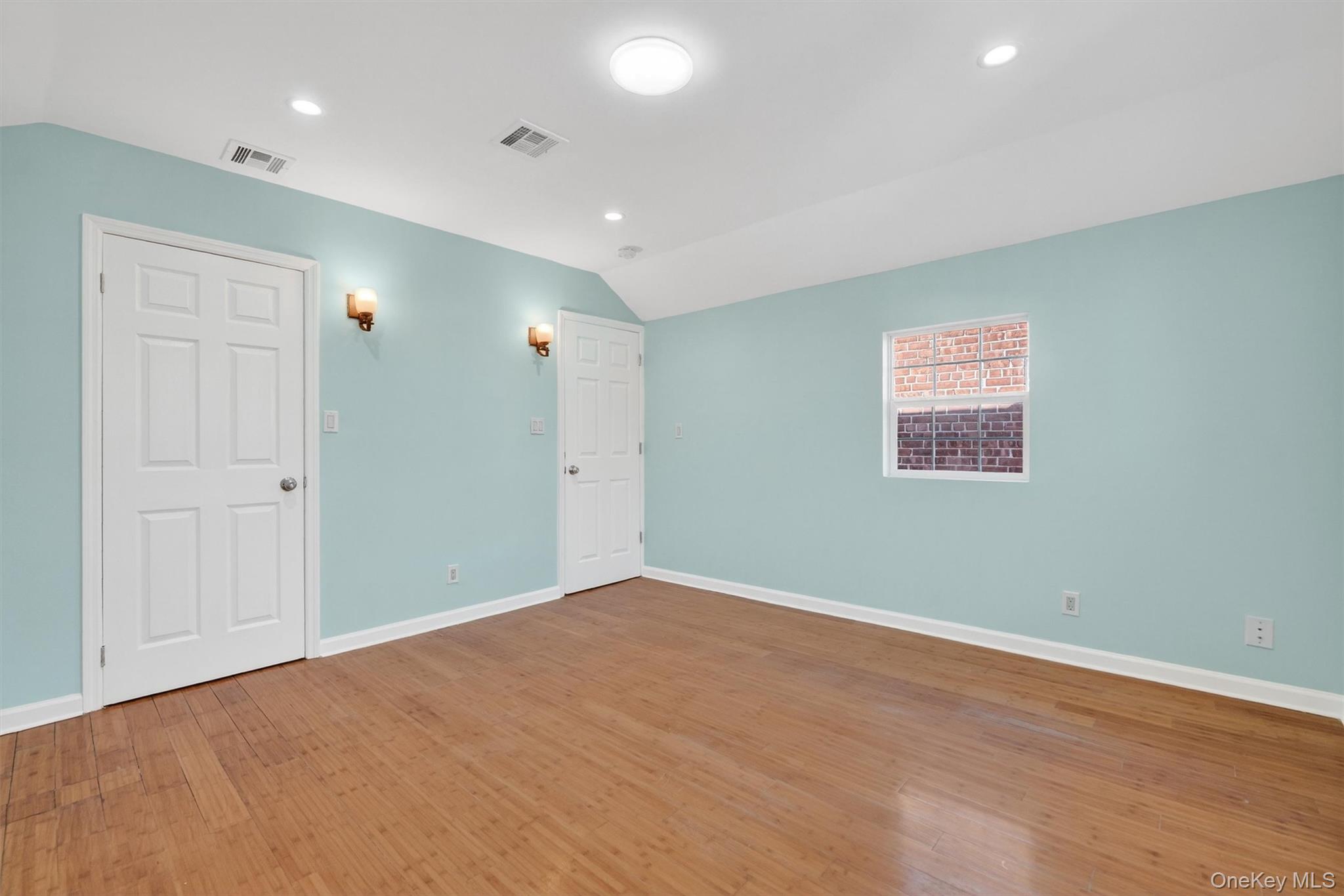 636 Throgs Neck Expressway Bronx, NY 10465 - Photo 26 of 31 Unfurnished bedroom with lofted ceiling, recessed lighting, and light wood-style floors