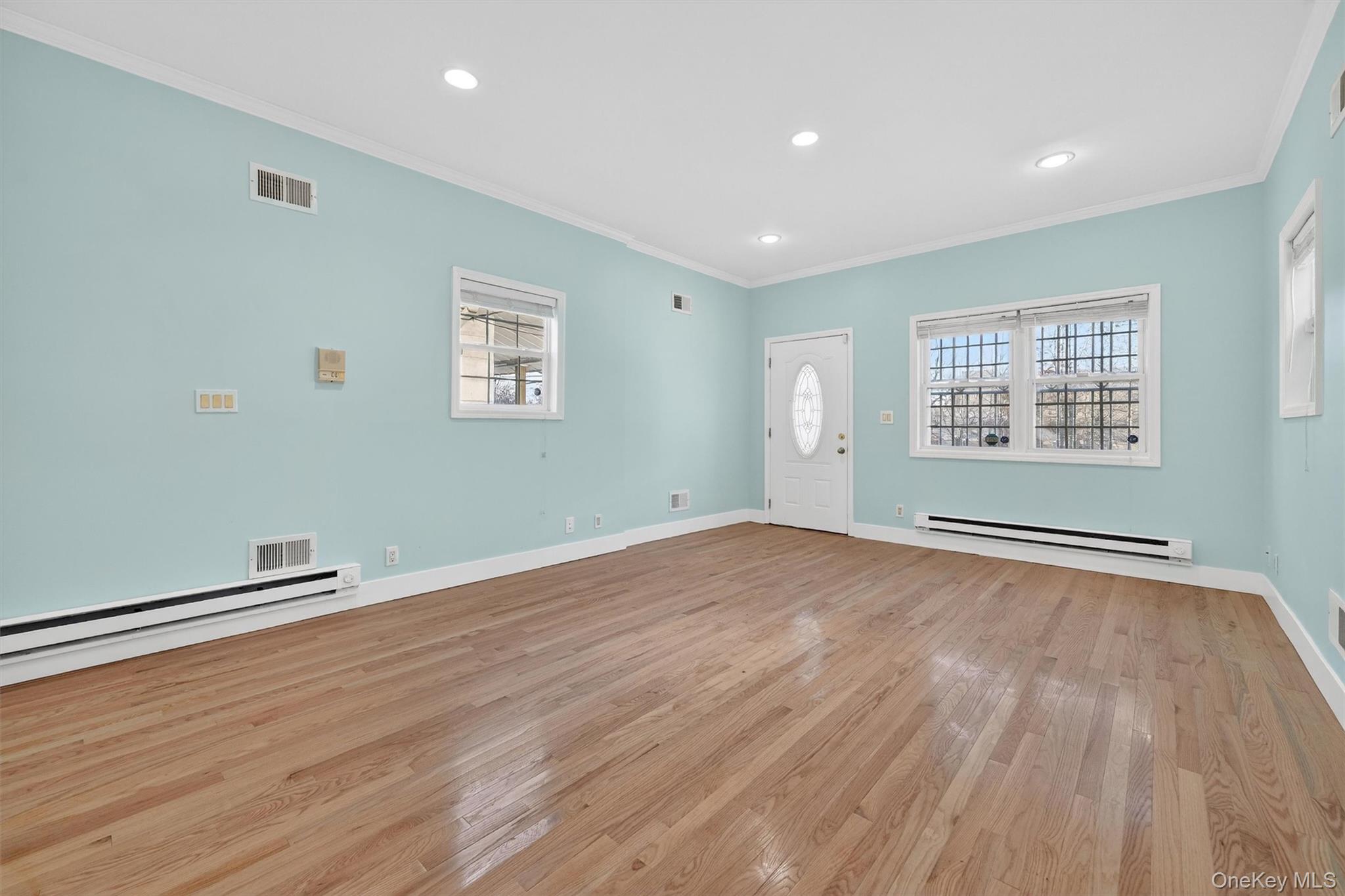 636 Throgs Neck Expressway Bronx, NY 10465 - Photo 6 of 31 Entryway featuring crown molding, recessed lighting, light wood-type flooring, and baseboard heating