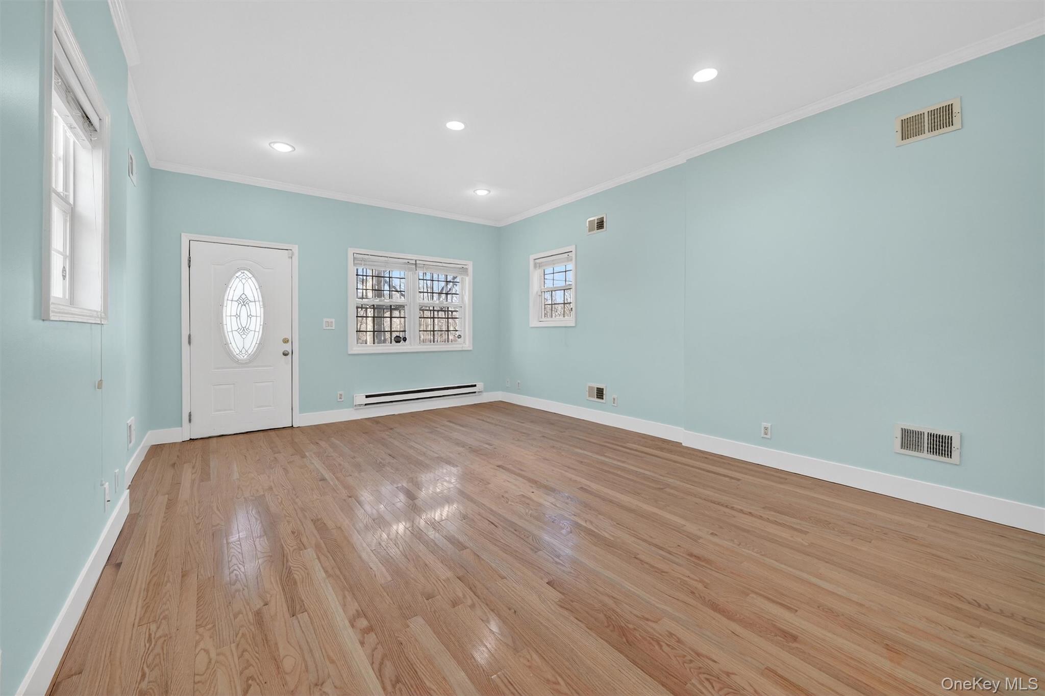 636 Throgs Neck Expressway Bronx, NY 10465 - Photo 8 of 31 Entryway with crown molding, light wood finished floors, recessed lighting, and a baseboard radiator