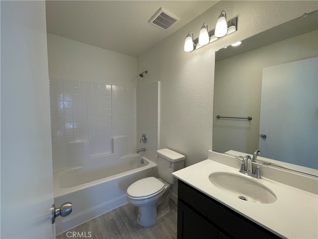 786 Stone Ridge Avenue Merced, CA 95341 - Photo 6 of 8 a bathroom with a sink a toilet a mirror and shower
