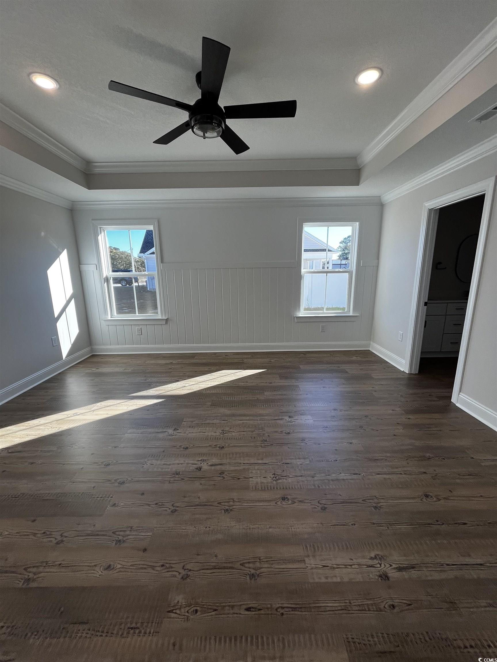 3428 Asbury Road Aynor, SC 29511 - Photo 5 of 10 Unfurnished room with healthy amount of natural light, dark wood-style flooring, crown molding, a tray ceiling, and recessed lighting