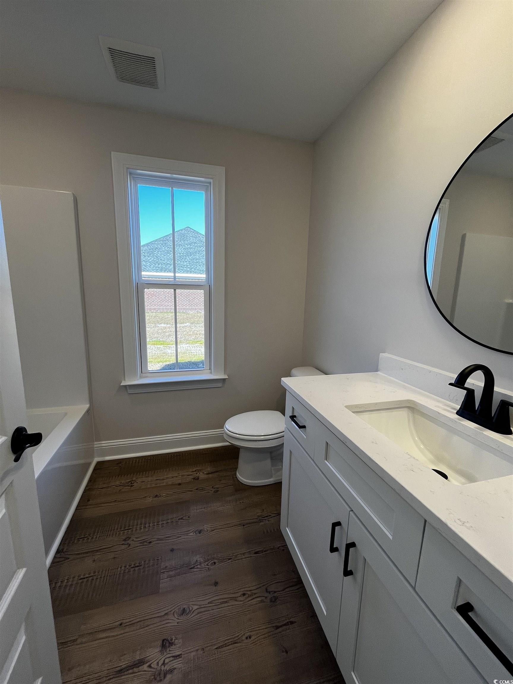 3428 Asbury Road Aynor, SC 29511 - Photo 9 of 10 Full bath with vanity, dark wood-type flooring, and shower / bathtub combination