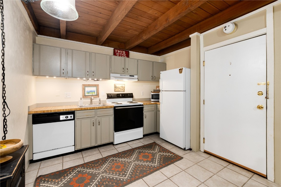 2200 Lodgepole Circle, Unit 105 Silverthorne, CO 80498 - Photo 3 of 36 a kitchen with stainless steel appliances granite countertop a refrigerator and a stove