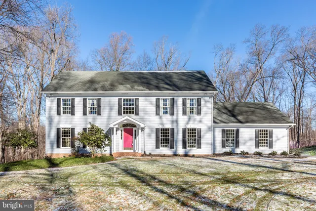 a view of a hallway with wooden floor and entryway