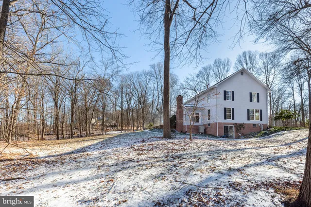 a living room with furniture a rug and a floor to ceiling window