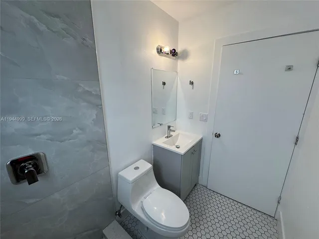 a white toilet sitting next to a bathroom sink