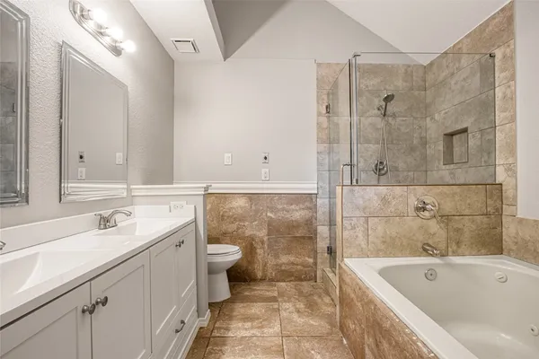 a bathroom with double sink and a mirror