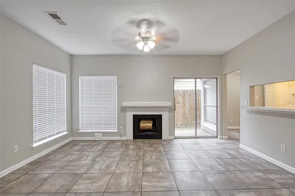 a view of a livingroom with a fireplace and window