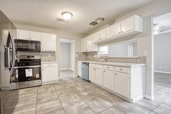 a kitchen with kitchen island granite countertop cabinets and steel stainless steel appliances