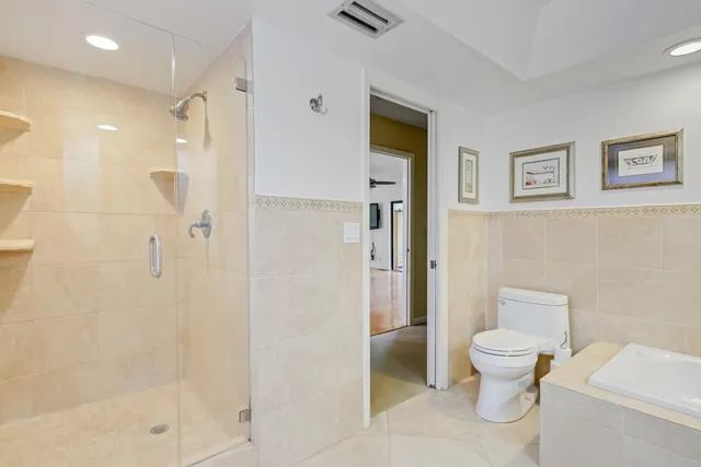 a bathroom with a toilet and a shower