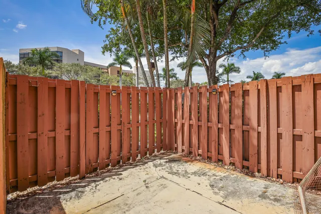 a view of a house with wooden fence