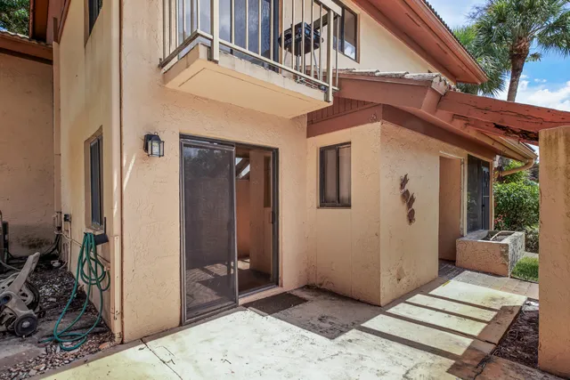 a view of a house with a wooden deck