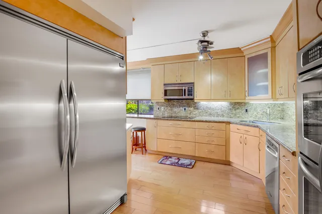 a kitchen with kitchen island granite countertop a cabinets and refrigerator