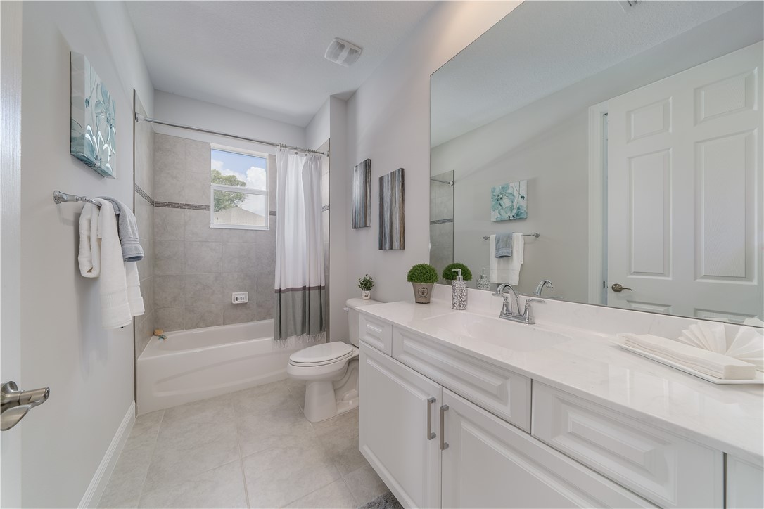 6145 Bella Rosa Lane Vero Beach, FL 32966 - Photo 5 of 8 a bathroom with a sink a toilet and shower