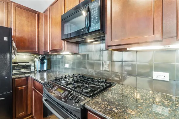 a picture of a room with a mirror and wooden floor