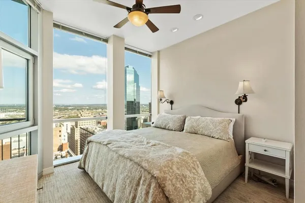 a bedroom with a large bed and a window