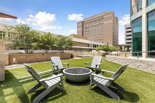 a view of a patio with couches table and chairs and potted plants