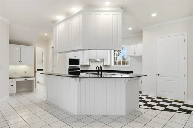 a kitchen with stainless steel appliances a sink and a refrigerator