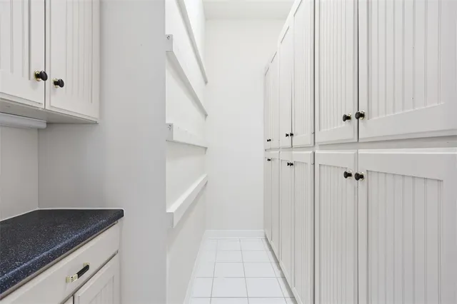 a view of entryway with white cabinet