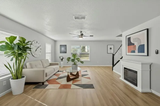 a living room with furniture a potted plant and a fireplace