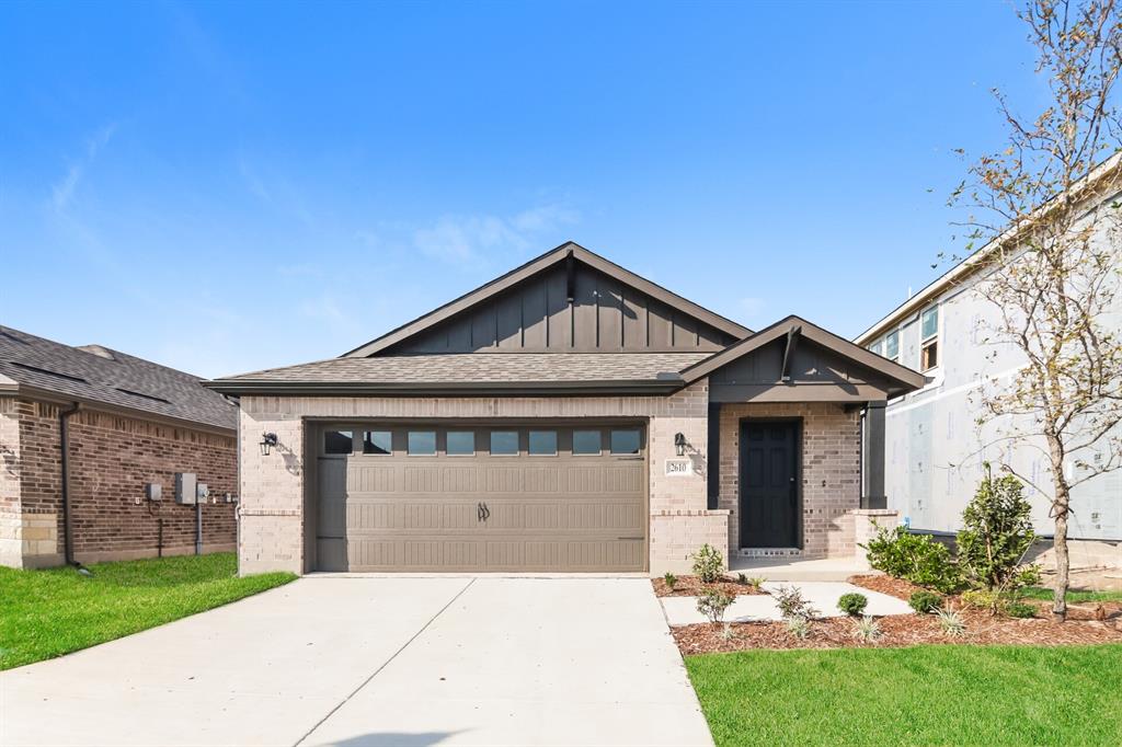 2610 Hawkins Street Anna, TX 75409 - Photo 1 of 17 View of front of home with board and batten siding, brick siding, driveway, an attached garage, and roof with shingles