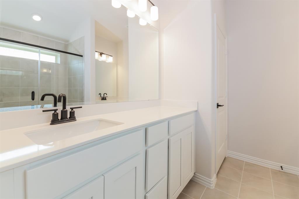 2610 Hawkins Street Anna, TX 75409 - Photo 11 of 17 Full bath featuring vanity, light tile patterned flooring, and a stall shower