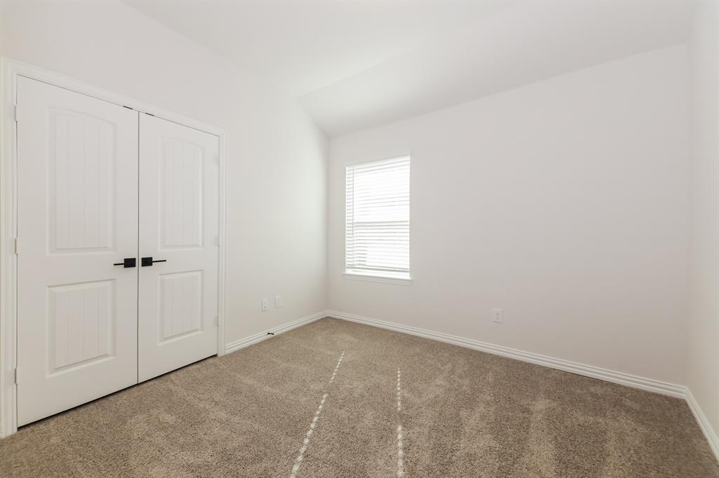 2610 Hawkins Street Anna, TX 75409 - Photo 12 of 17 Unfurnished bedroom with carpet floors, a closet, and lofted ceiling
