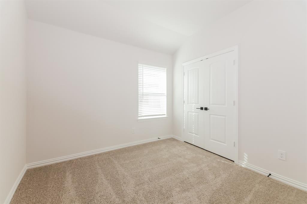 2610 Hawkins Street Anna, TX 75409 - Photo 13 of 17 Unfurnished bedroom with carpet and a closet
