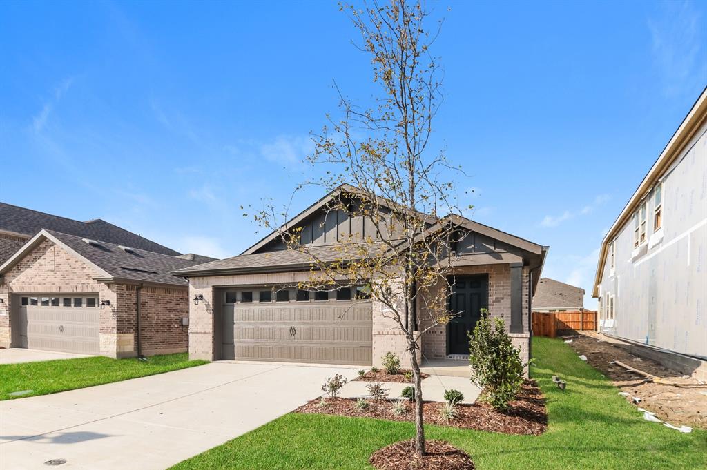 2610 Hawkins Street Anna, TX 75409 - Photo 2 of 17 View of front of home with brick siding, board and batten siding, concrete driveway, and a garage