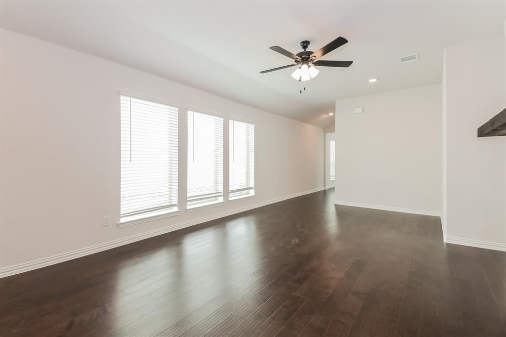 2610 Hawkins Street Anna, TX 75409 - Photo 5 of 17 Unfurnished living room with lofted ceiling, dark wood-type flooring, recessed lighting, and a ceiling fan