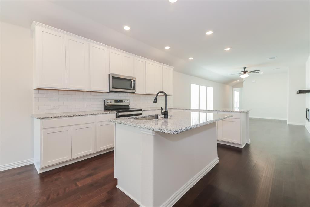 2610 Hawkins Street Anna, TX 75409 - Photo 8 of 17 Kitchen featuring white cabinetry, decorative backsplash, stainless steel appliances, a peninsula, and recessed lighting