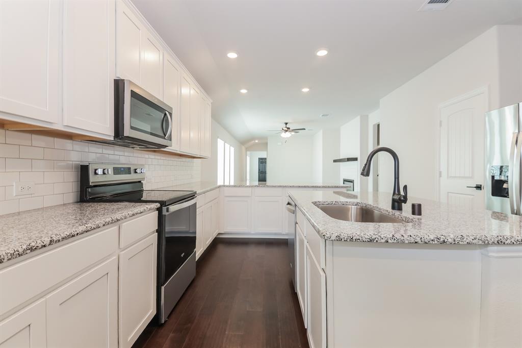 2610 Hawkins Street Anna, TX 75409 - Photo 9 of 17 Kitchen featuring stainless steel appliances, recessed lighting, a peninsula, dark wood-type flooring, and white cabinetry