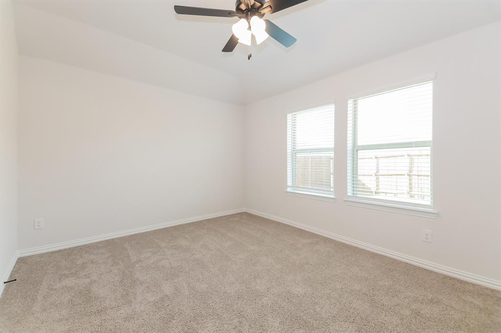 2610 Hawkins Street Anna, TX 75409 - Photo 10 of 17 Carpeted empty room featuring a ceiling fan and vaulted ceiling