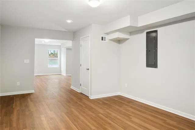a view of a hallway with wooden floor