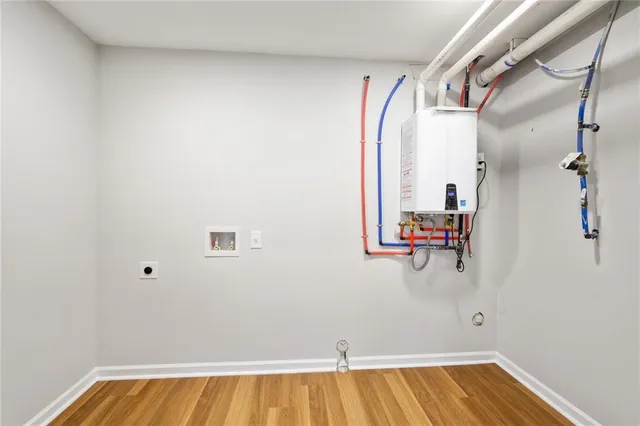 a view of a room with wooden floor and bathroom