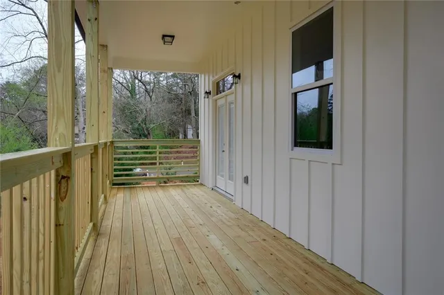 a view of outdoor space with wooden floor and windows