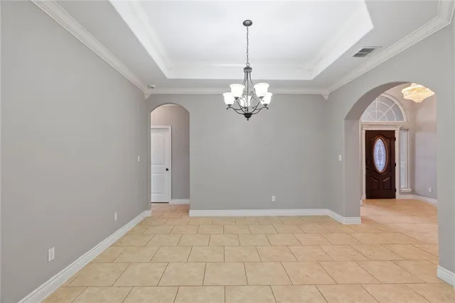 a view of a big room with chandelier and entryway