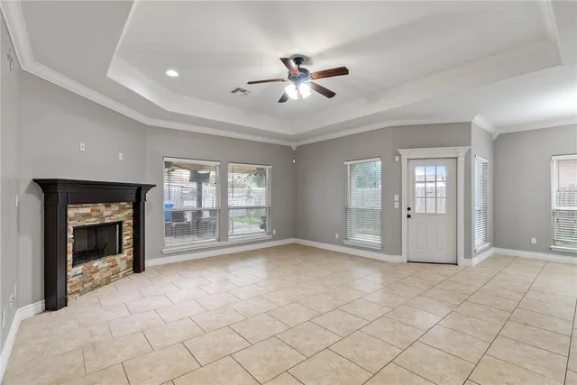 a view of an empty room with window and fire place