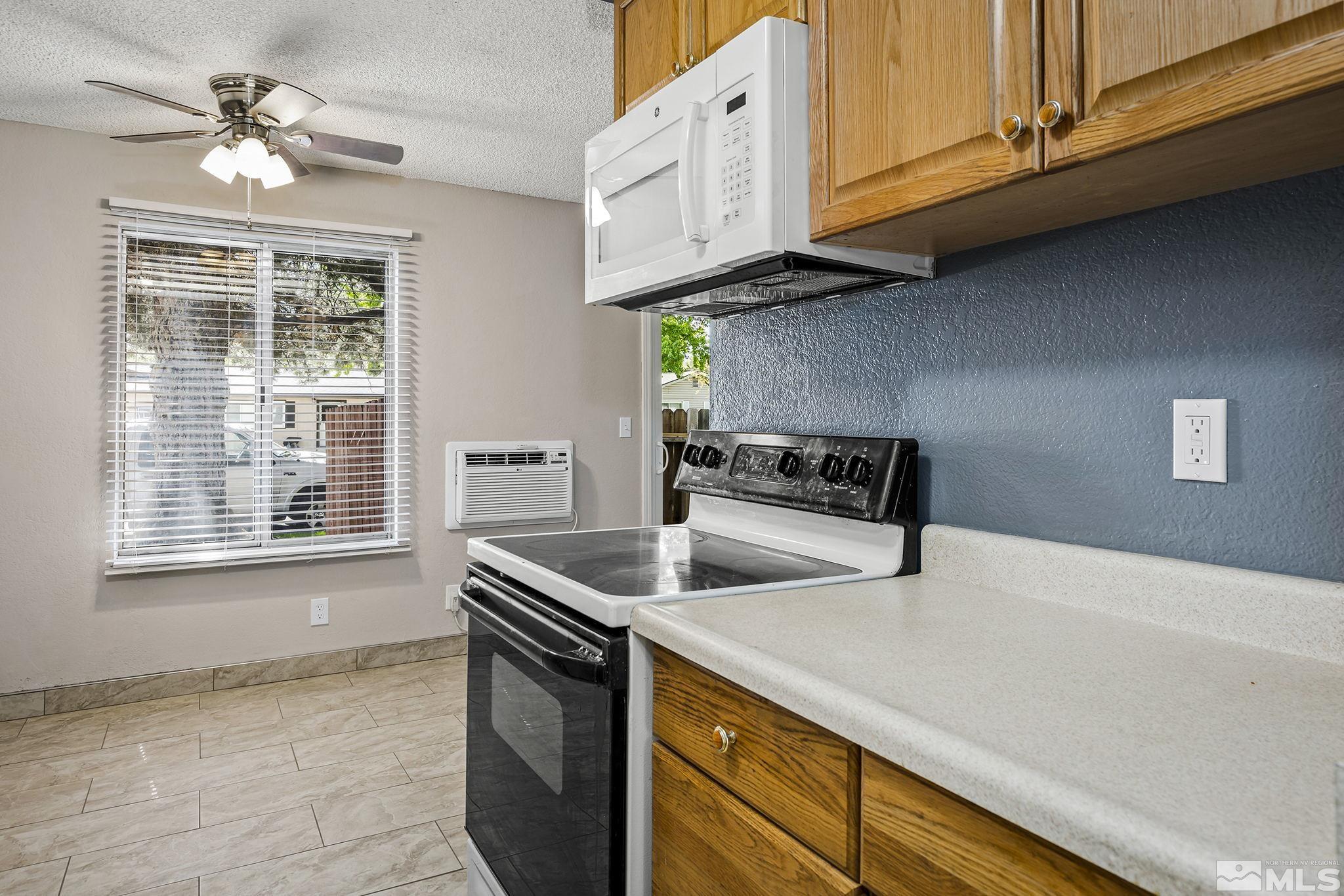 4600 Neil Road, Unit 3 Reno, NV 89502 - Photo 4 of 14 a kitchen with stainless steel appliances granite countertop a sink a stove and a white cabinets