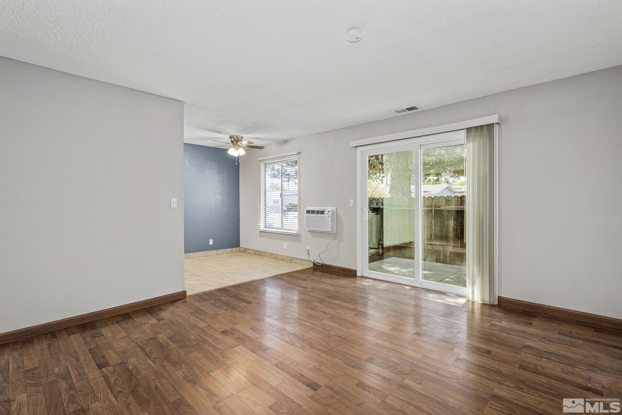 4600 Neil Road, Unit 3 Reno, NV 89502 - Photo 5 of 14 a view of an empty room with wooden floor and a window