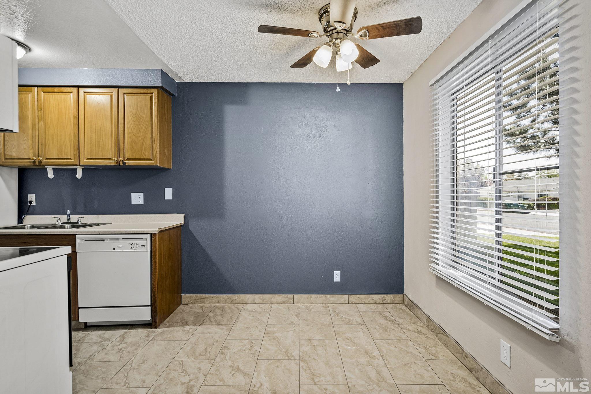 4600 Neil Road, Unit 3 Reno, NV 89502 - Photo 6 of 14 a kitchen with a stove a sink and a microwave