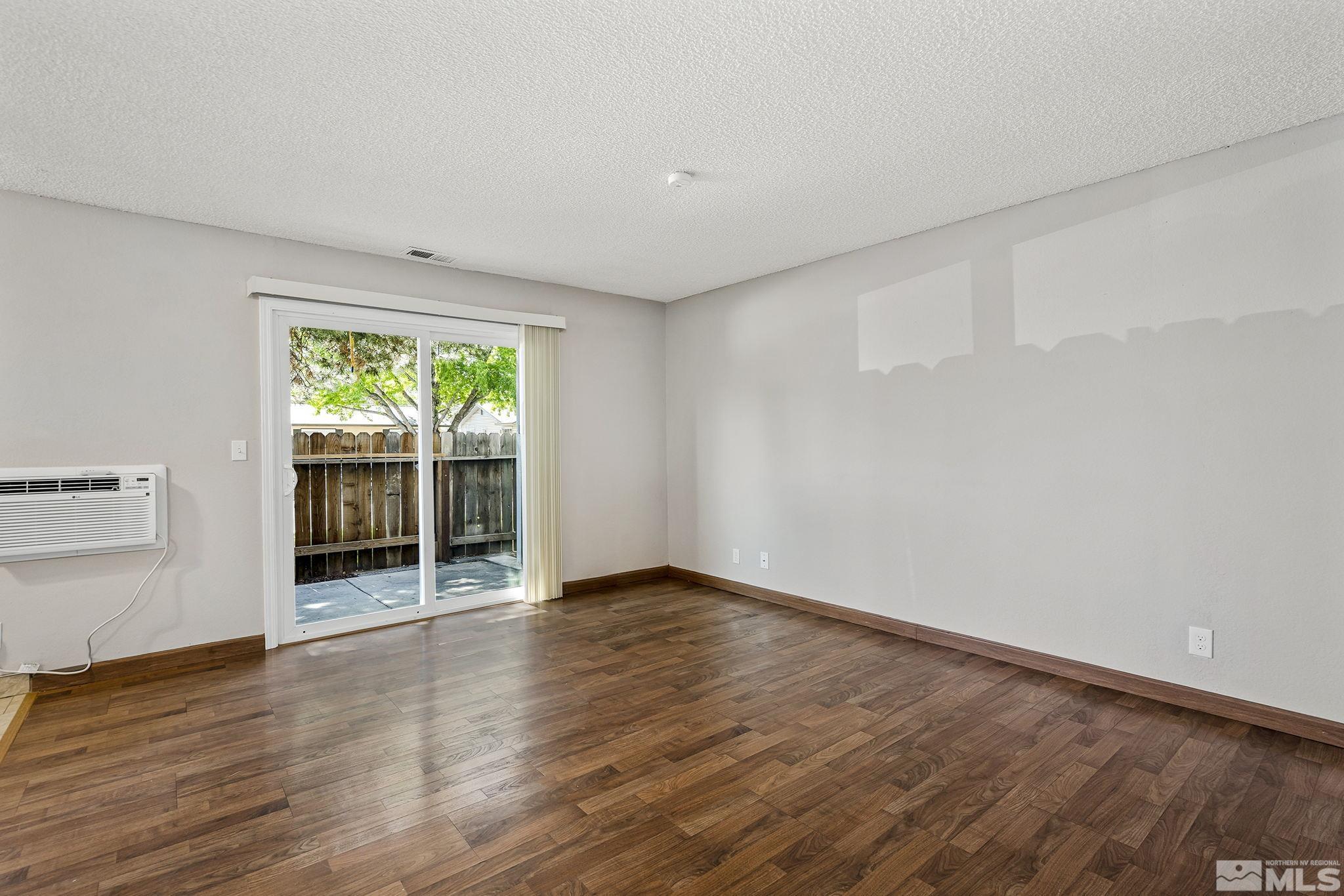 4600 Neil Road, Unit 3 Reno, NV 89502 - Photo 8 of 14 an empty room with wooden floor and windows