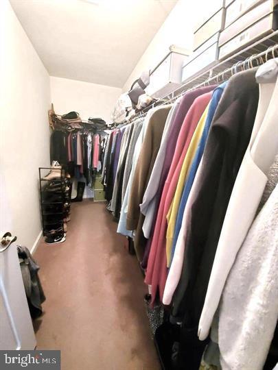 525 Timberlake Drive Ewing, NJ 08618 - Photo 13 of 27 a view of walk in closet with clothes and shoes